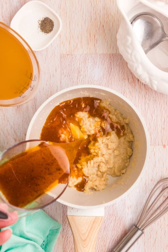 pan drippings pouring into a saucepan.