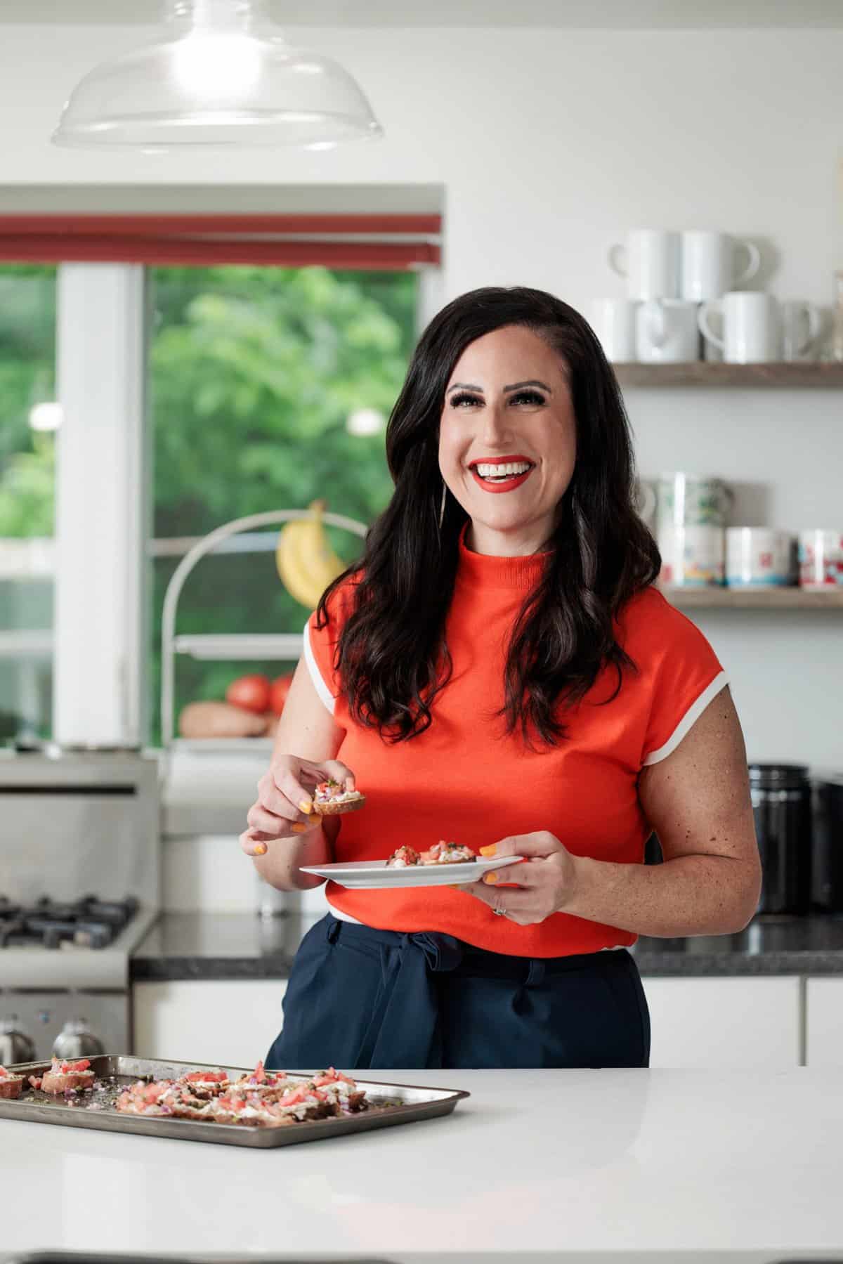 Liz eating easy crostini with smoked fish and dill.