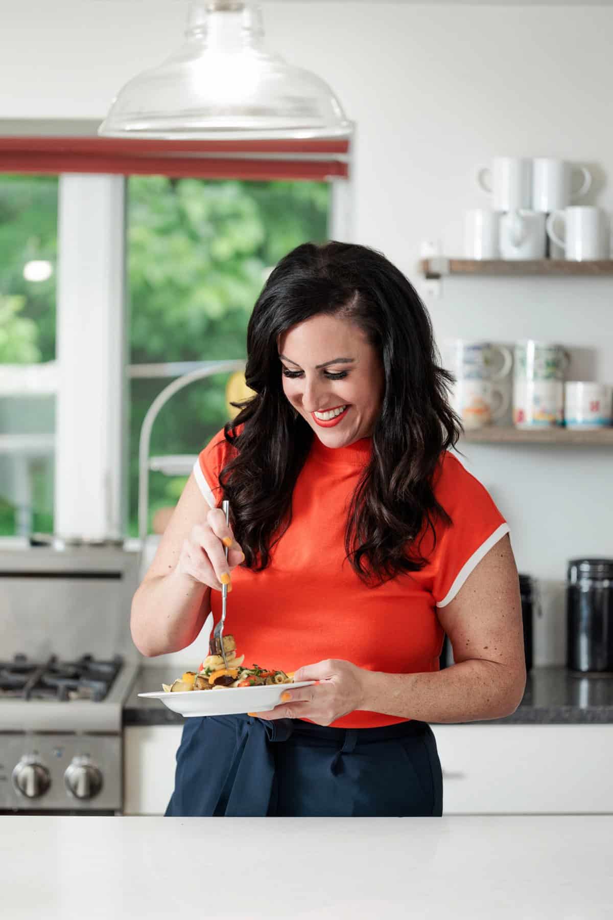 Liz eating grilled vegetable pasta.