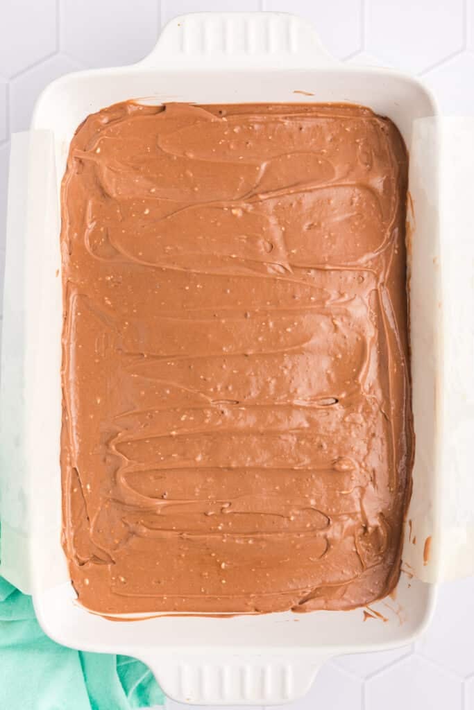 overhead shot of a pudding layer spread into a baking dish.