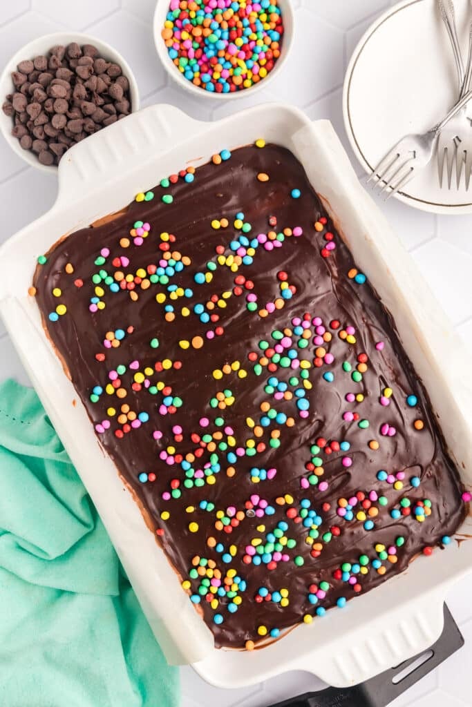 overhead shot of brownie lush topped with rainbow chips in a baking dish.