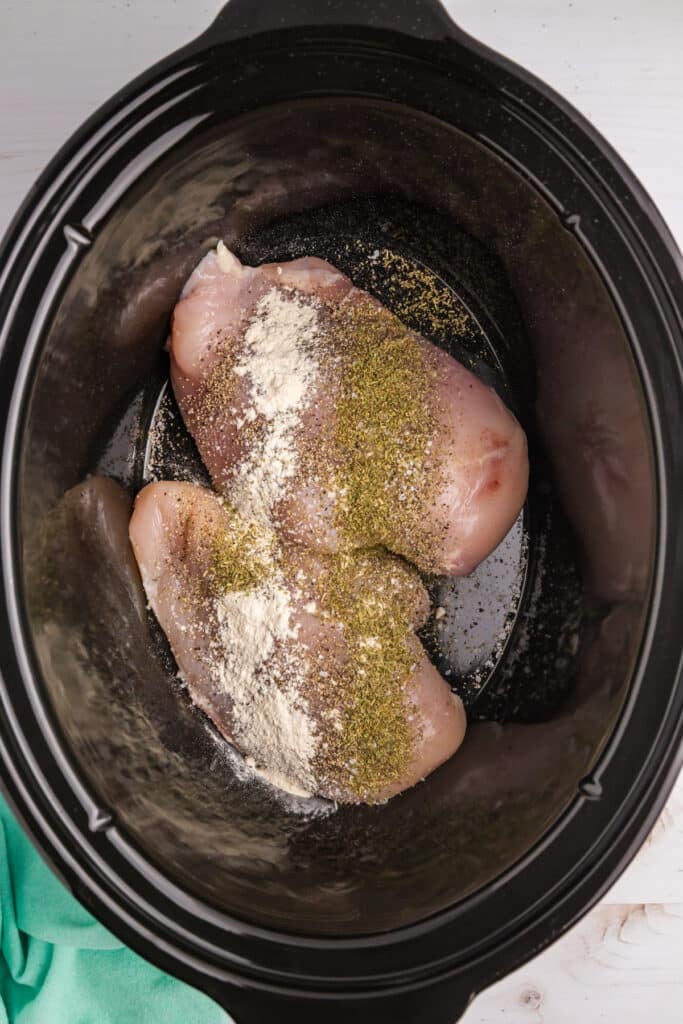 seasoned chicken breasts in a slow cooker.