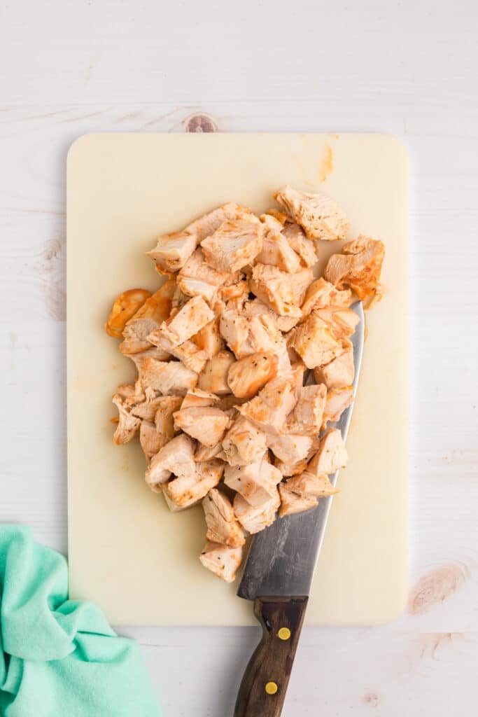 diced chicken on a cutting board.