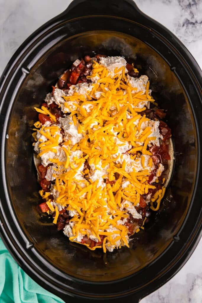 shredded cheese topping a crockpot casserole.