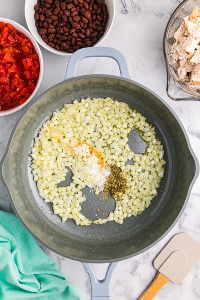 onions and seasonings sauteing in a pan.