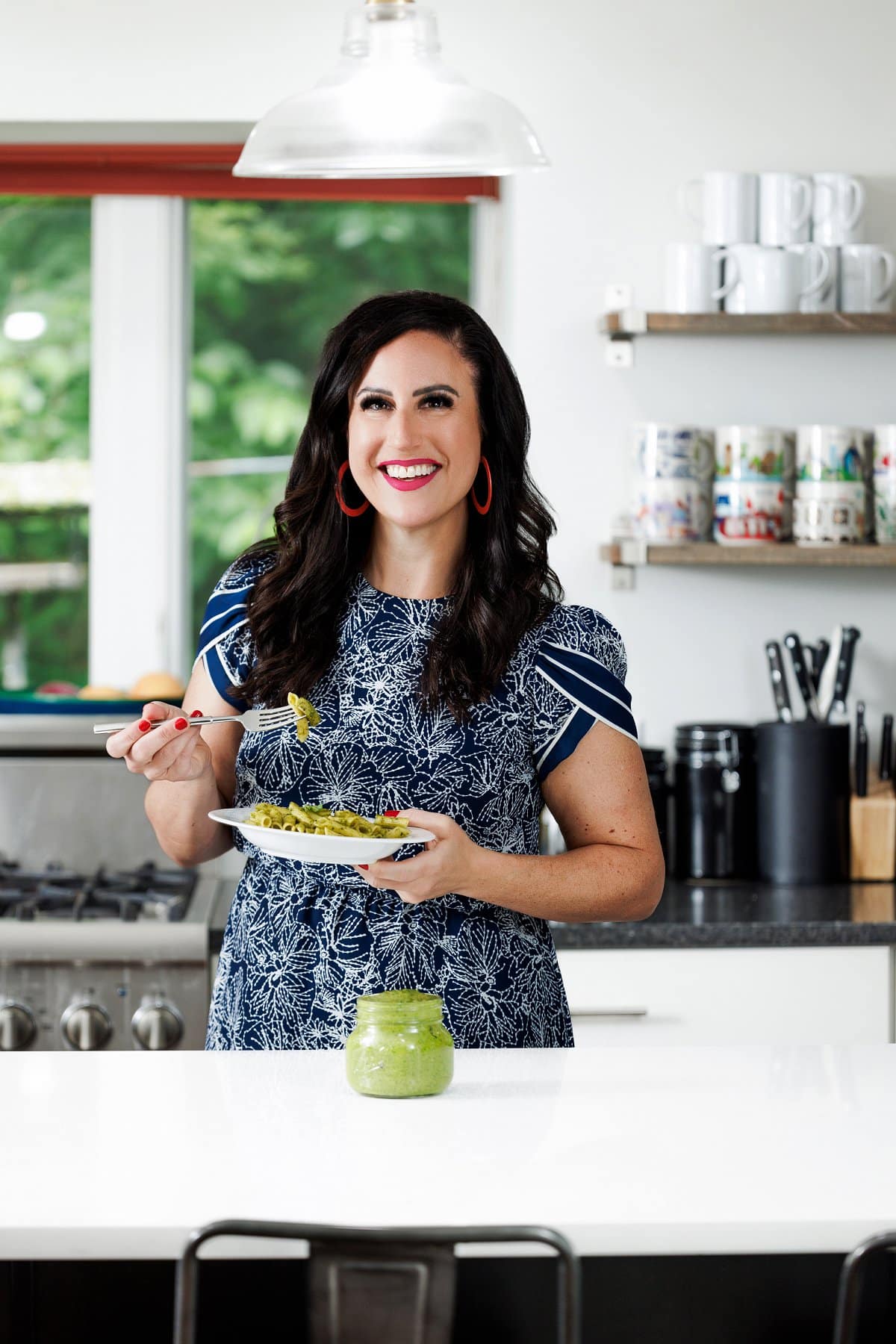 Liz eating basil pistachio pesto on pasta.