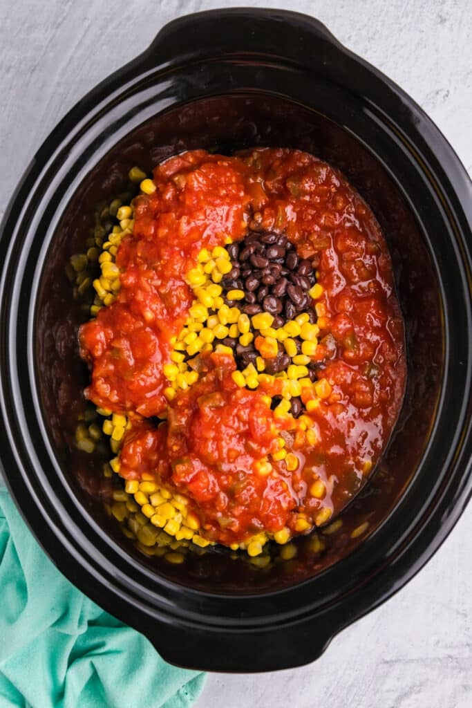 corn, black beans, and salsa in a crockpot.