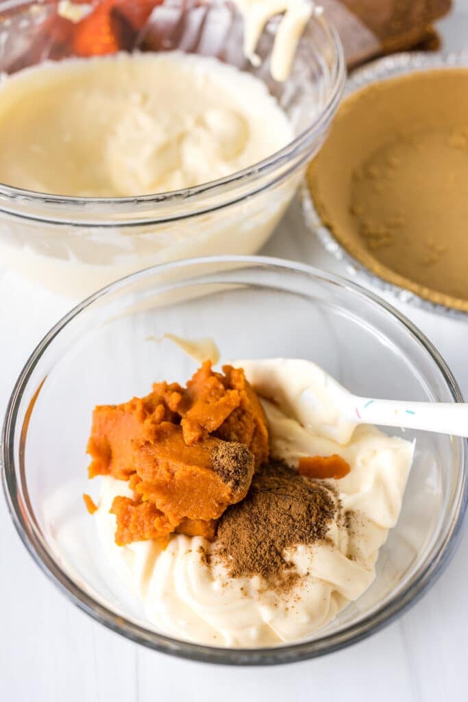 canned pumpkin stirring into cheesecake batter.
