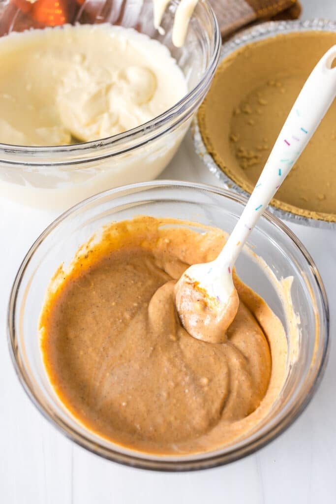 pumpkin cheesecake batter in a mixing bowl.