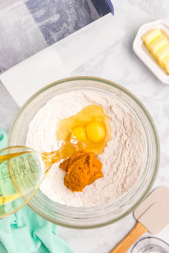 pumpkin and eggs in a mixing bowl of dry ingredients.