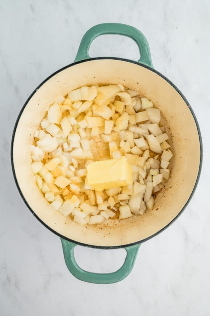 overhead shot of pot with butter and diced onions.
