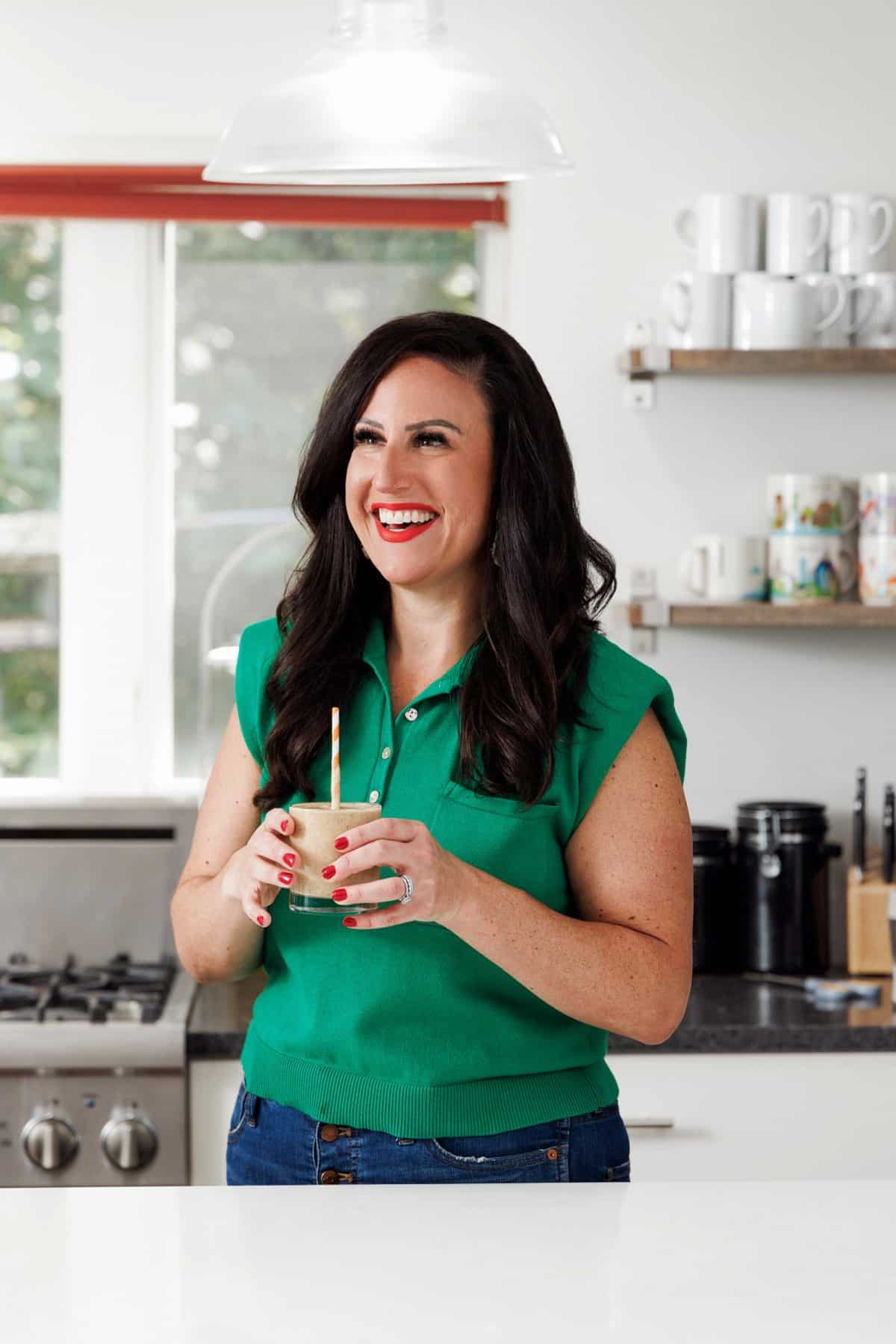 Liz drinking a peach protein smoothie.