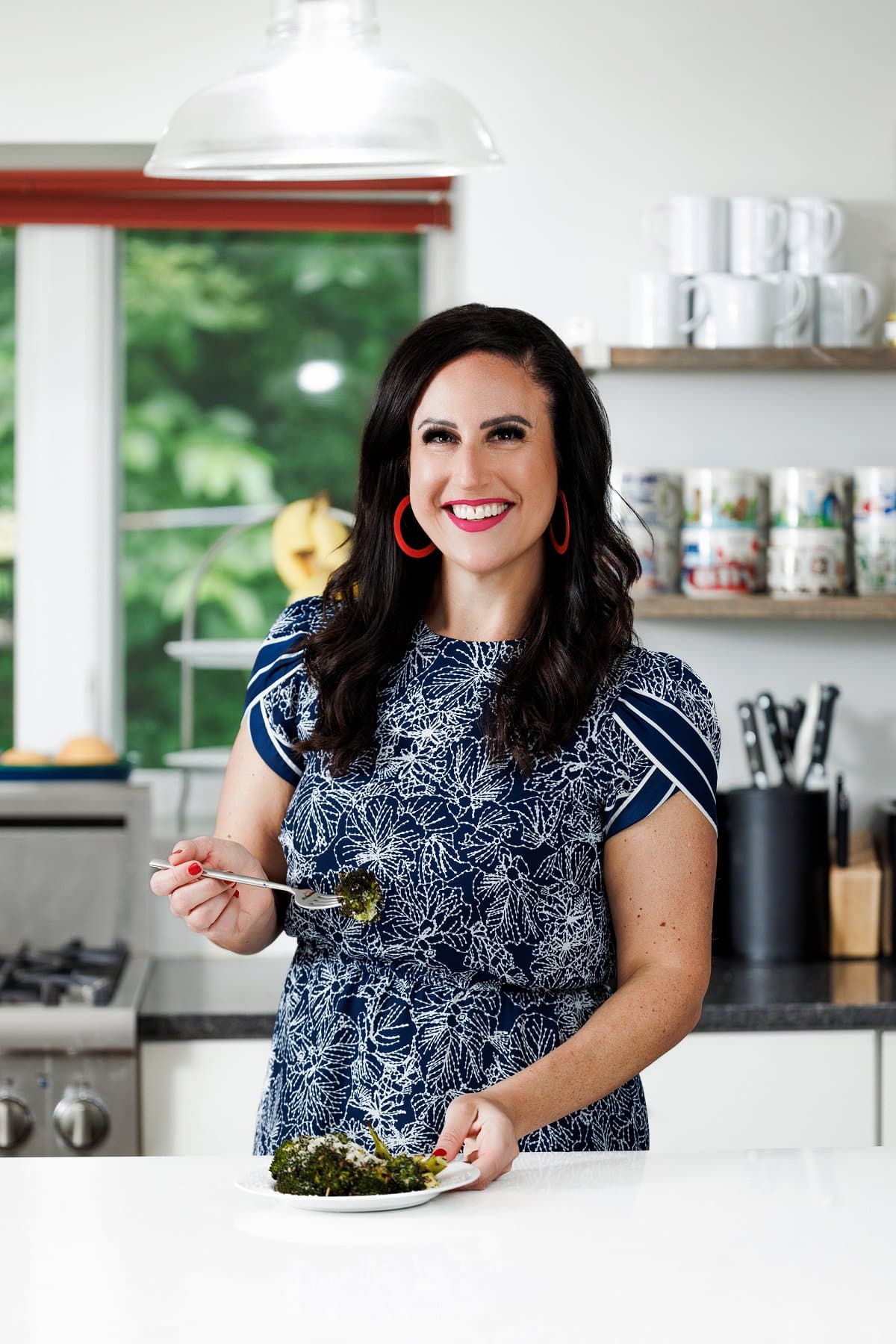 Liz eating Italian herb roasted broccoli.