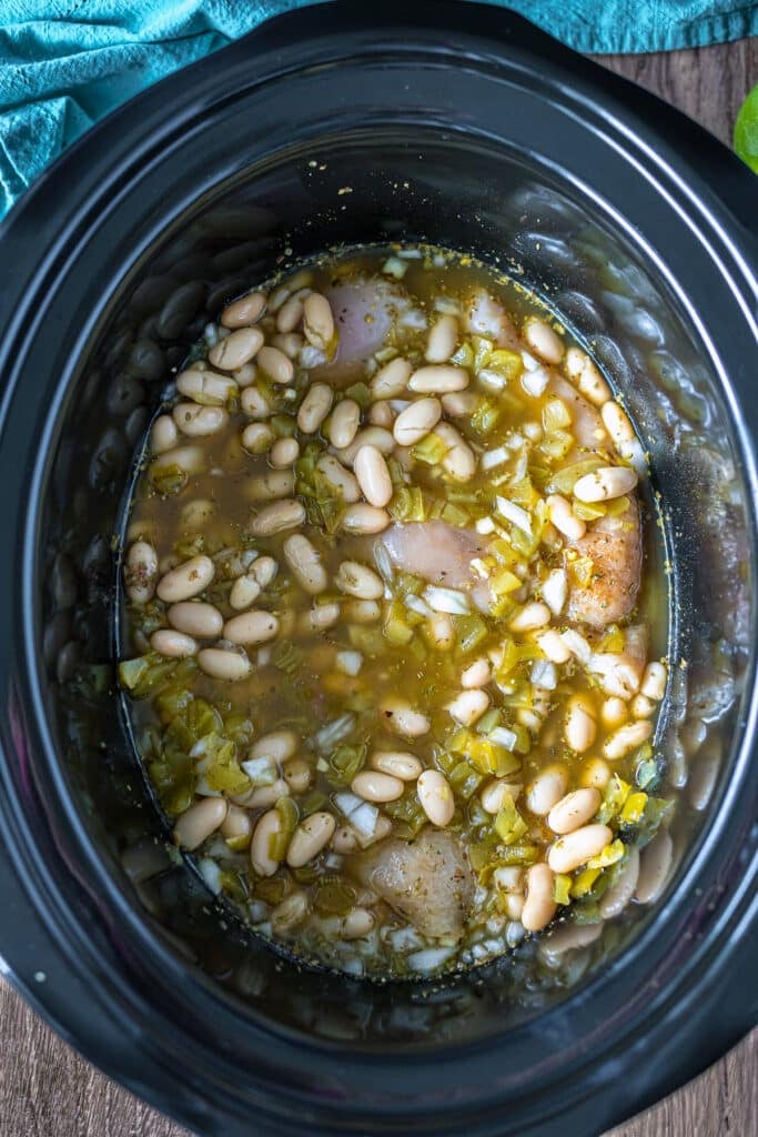 overhead shot of beans and broth in a crockpot.