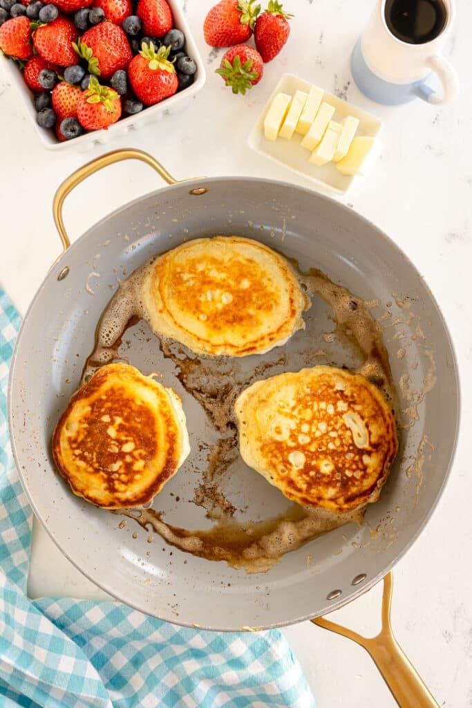 three pancakes in a skillet.