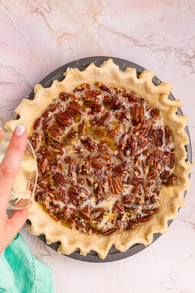 overhead shot of a pecan pie before baking.