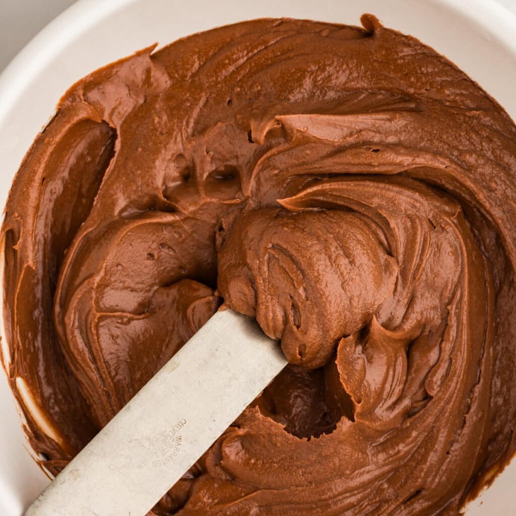 cocoa powder frosting on a spatula.