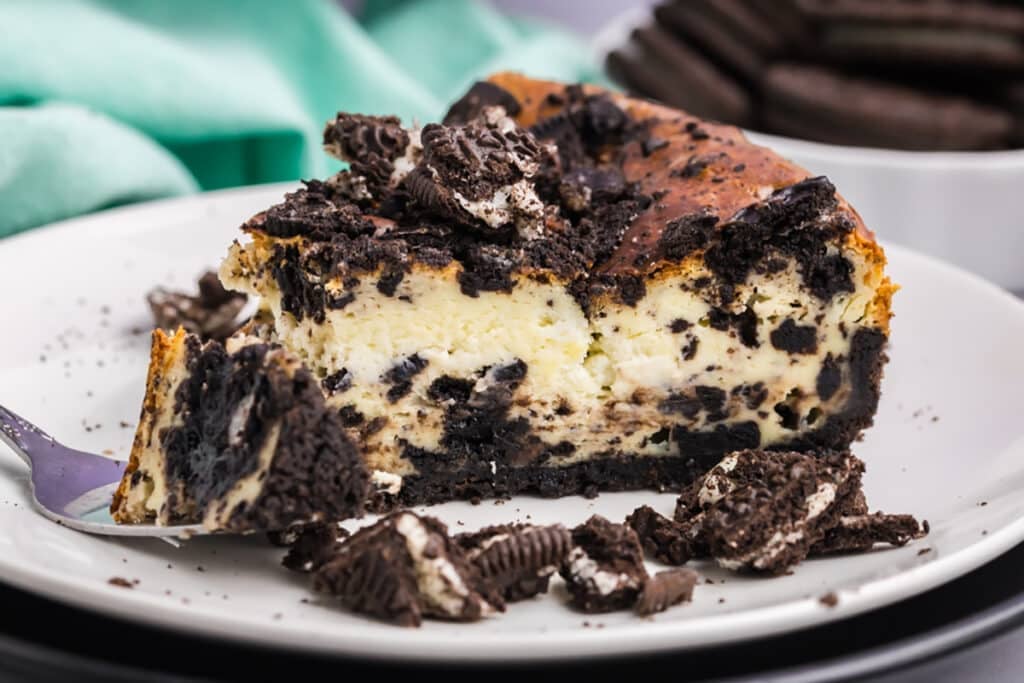 A partially eaten slice of cheesecake with a fork.