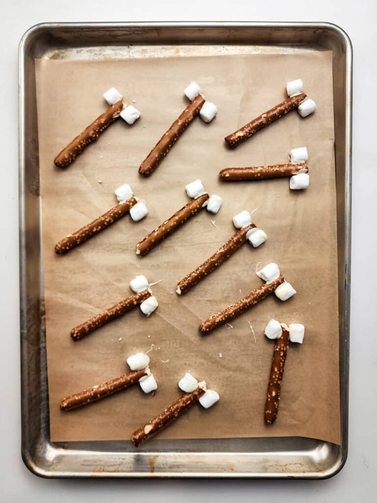 pretzel sticks with two marshmallows on the ends to look like bones.