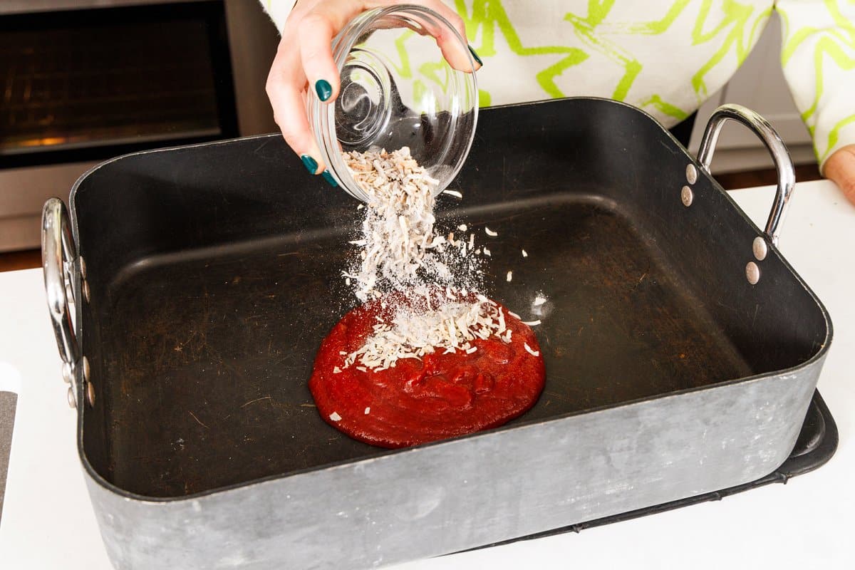 Adding onion soup mix to chili sauce in the bottom of a roasting pan.