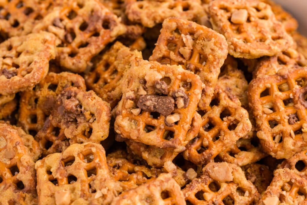 Close-up of butter toffee pretzels with chocolate and toffee bits.