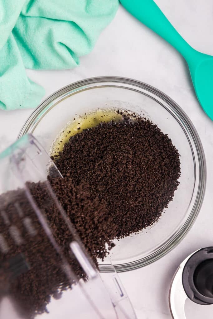 Oreo crumbs poured into melted butter.
