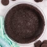 A completed Oreo pie crust in a glass dish.