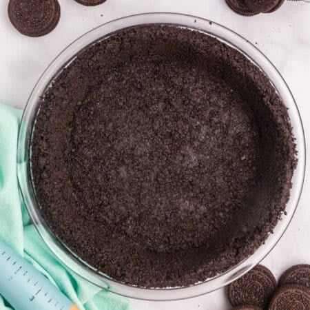 A completed Oreo pie crust in a glass dish.