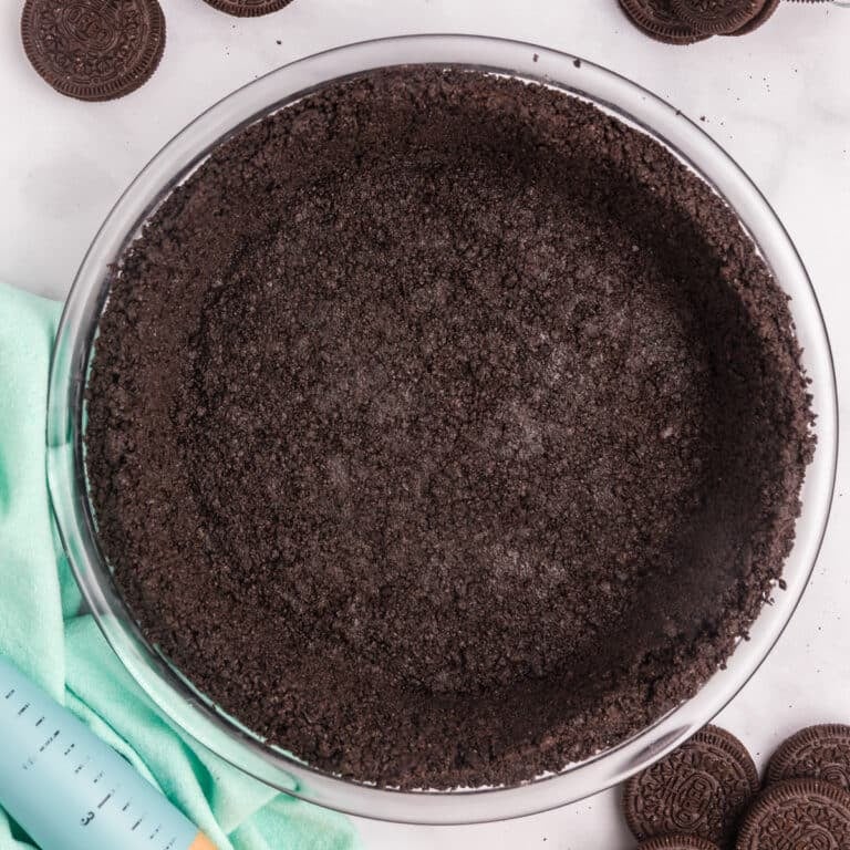 A completed Oreo pie crust in a glass dish.
