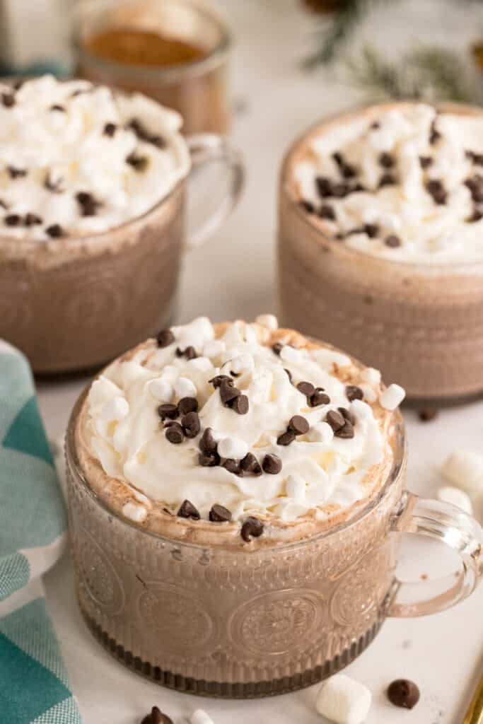 Top view of three mugs filled with smooth hot chocolate.