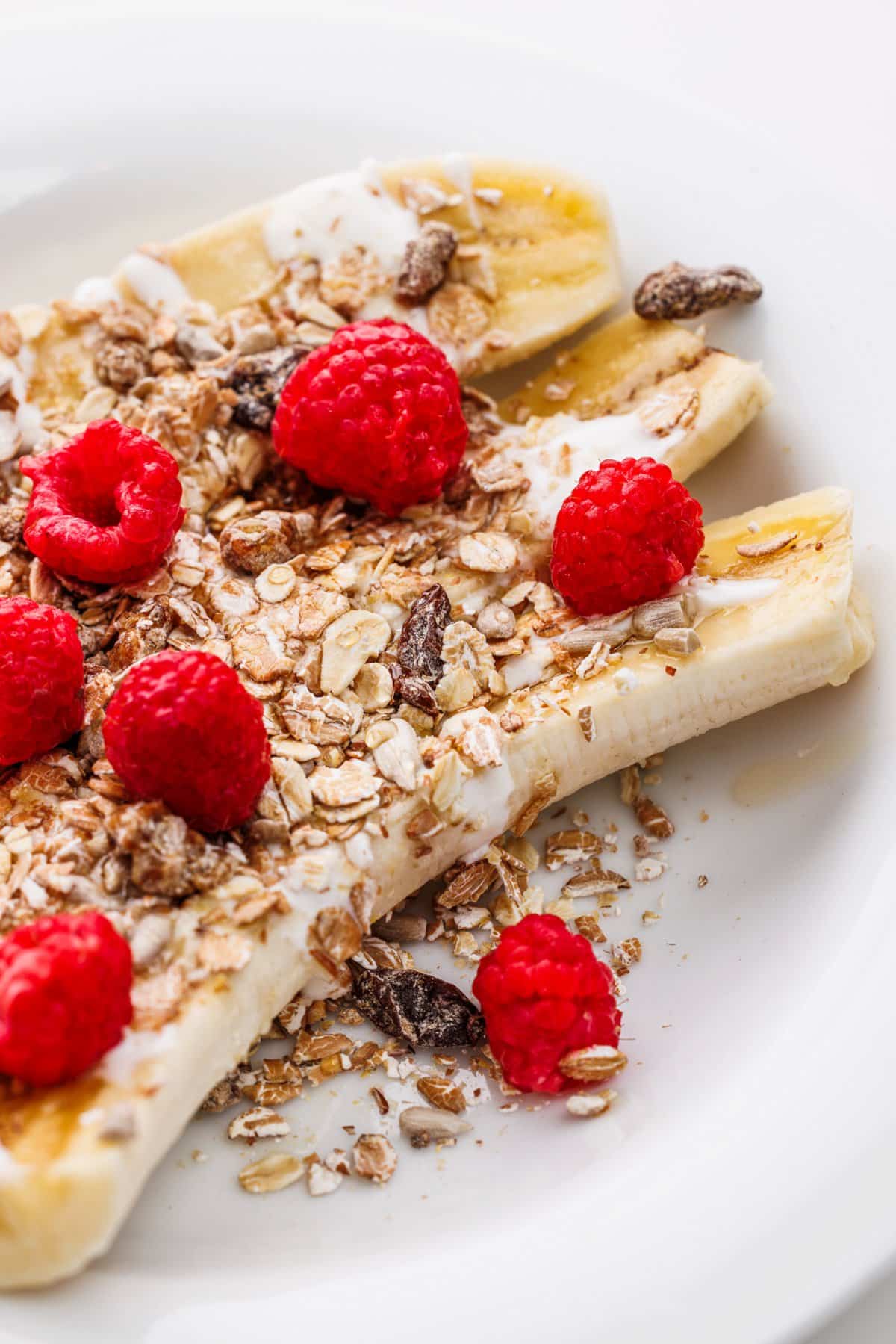 Yogurt splits with muesli and berries up close.