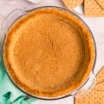Golden graham cracker crust in a glass pie dish.