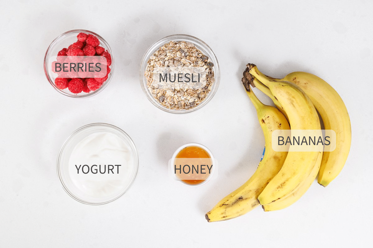Labeled ingredients for yogurt banana splits with muesli.
