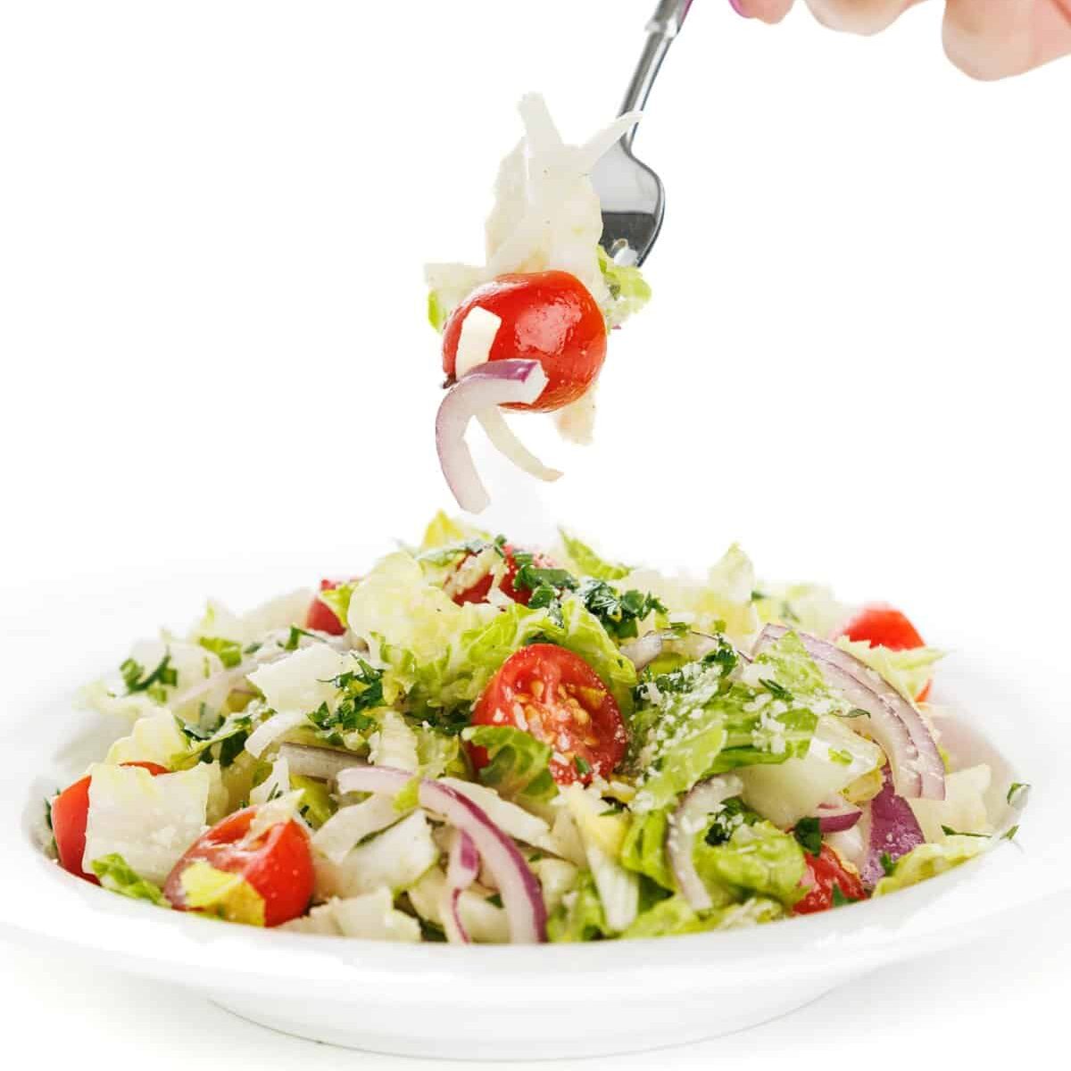 Forkful of Italian garden salad with fennel.