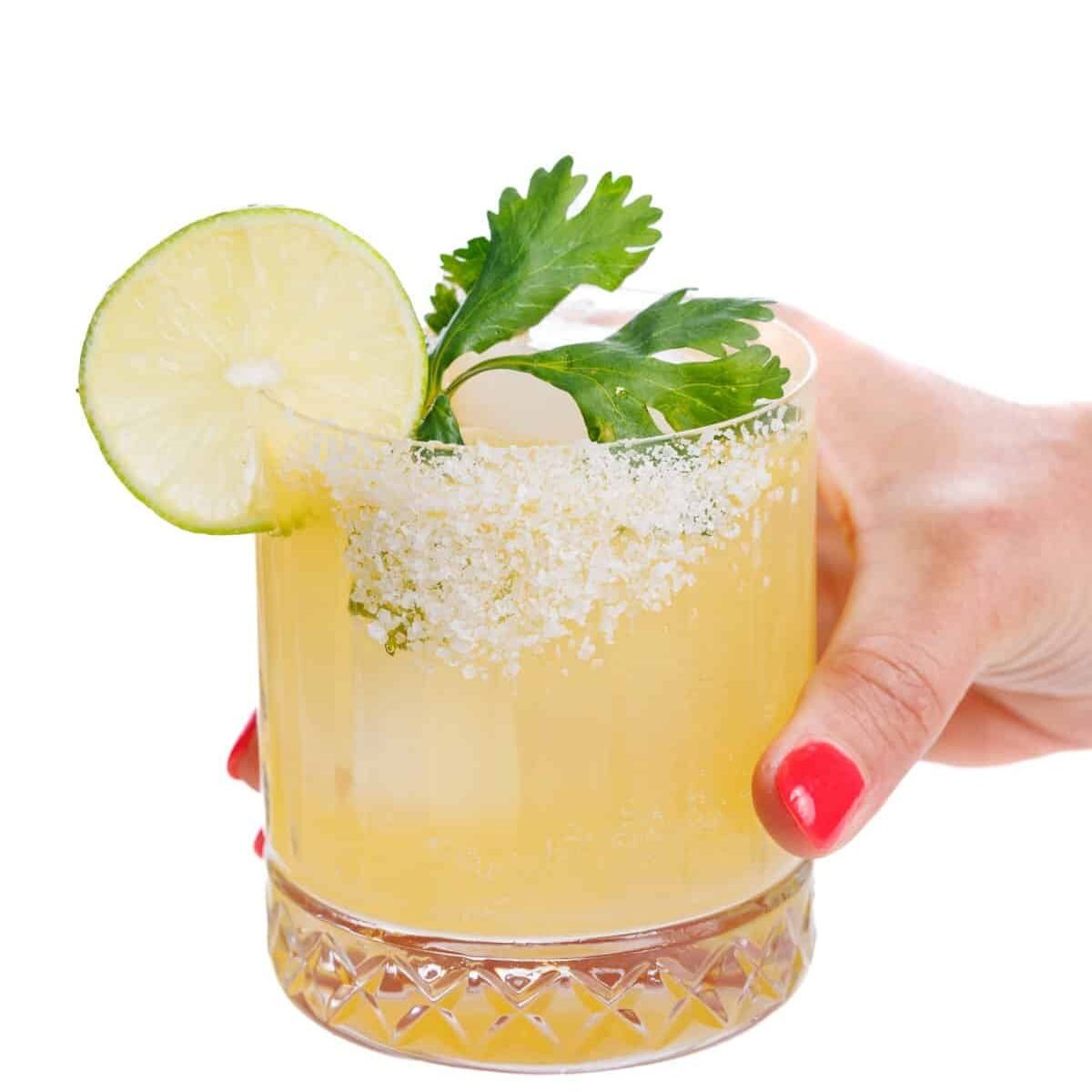 Holding a cilantro margarita.