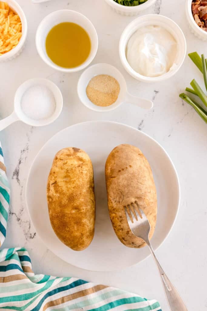 fork poking holes into a potato.