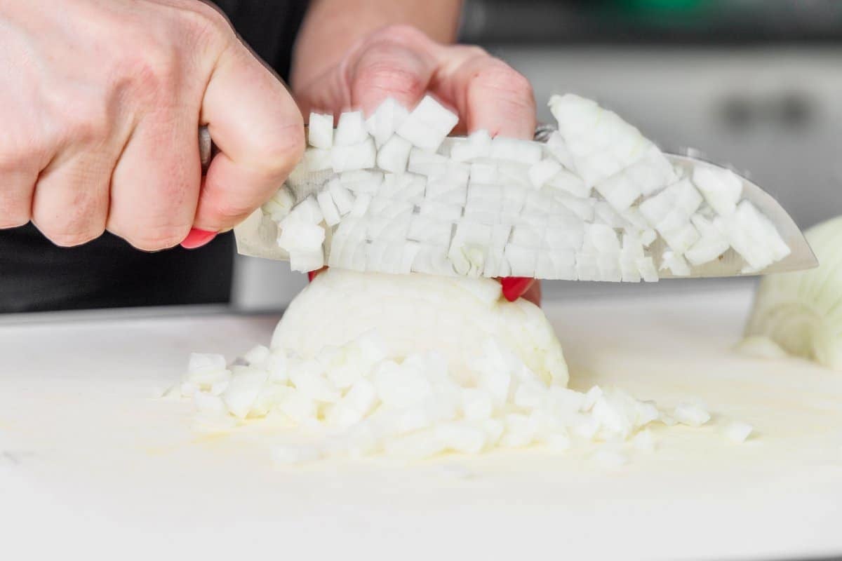 Liz dicing a white onion.