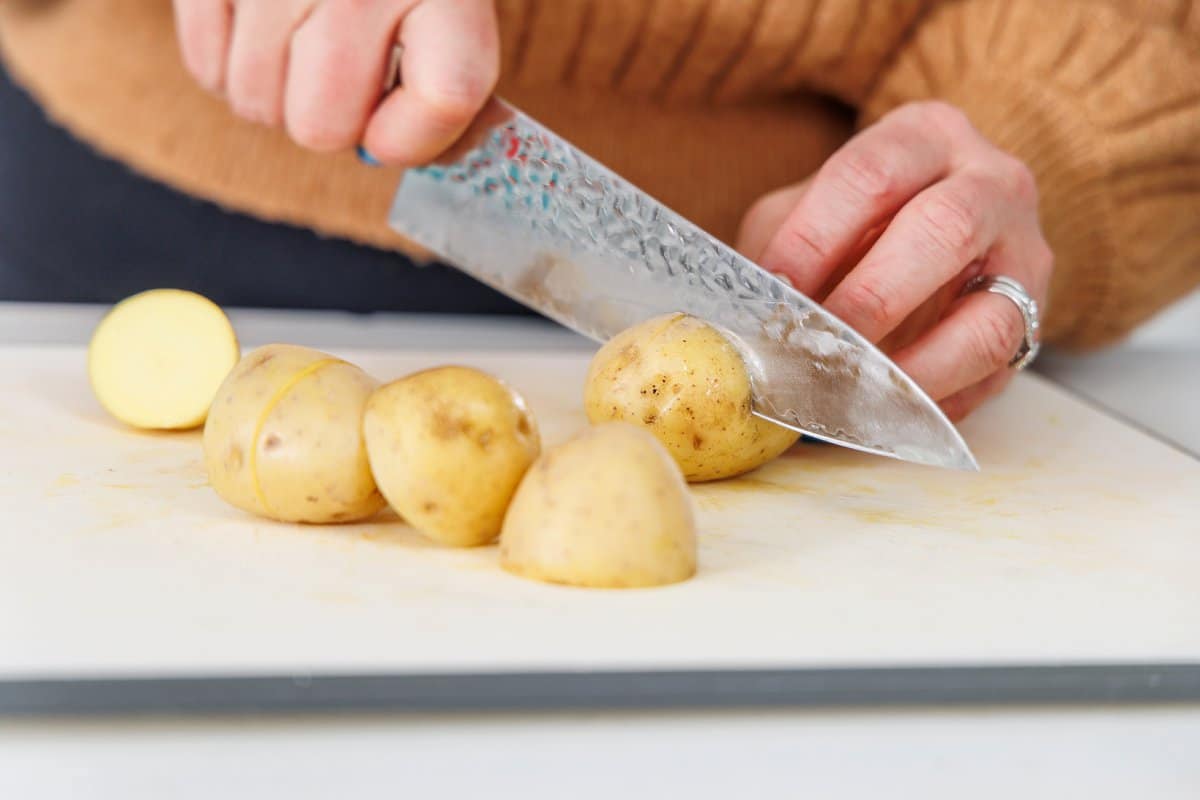 Liz cutting potatoes into quarters.