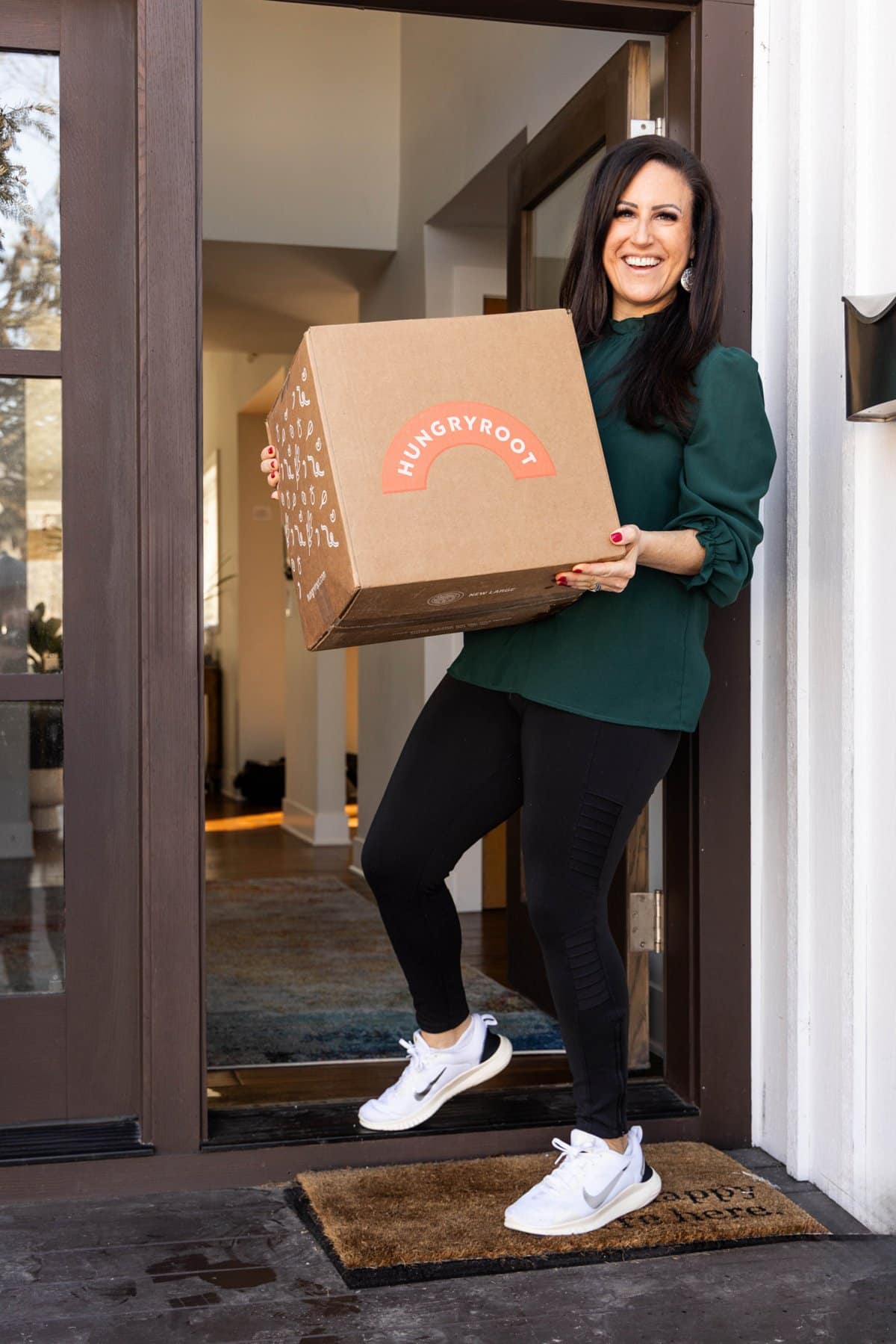 Liz holding up her box from Hungryroot.