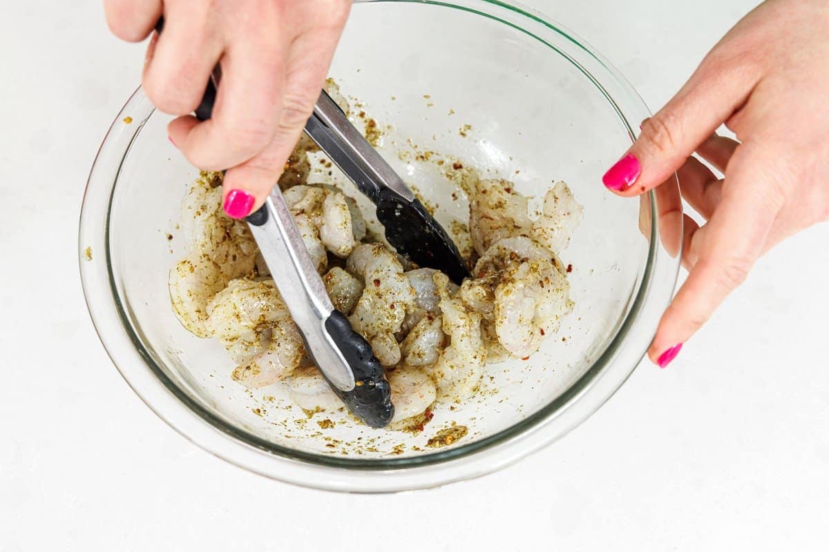 Tossing shrimp in marinade.