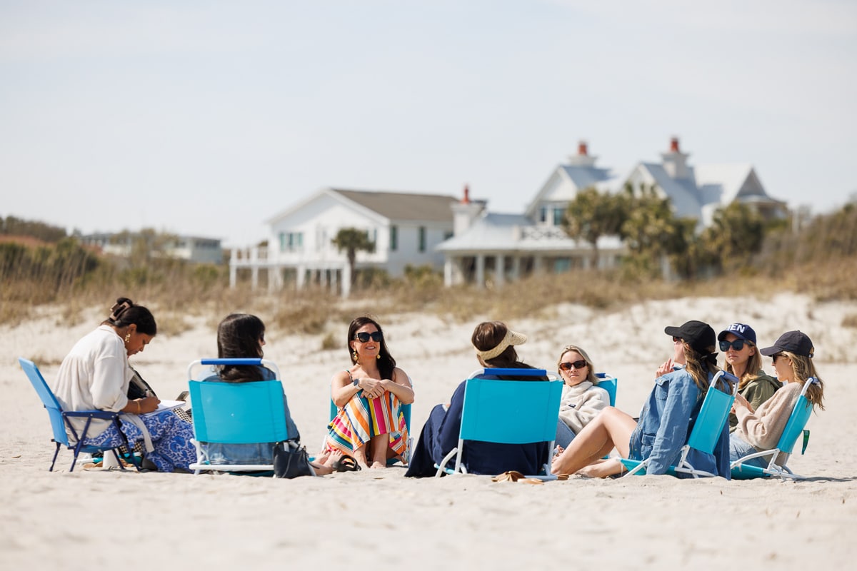 Fresh Air Retreat attendees lounging on a sandy beach in Charleston.