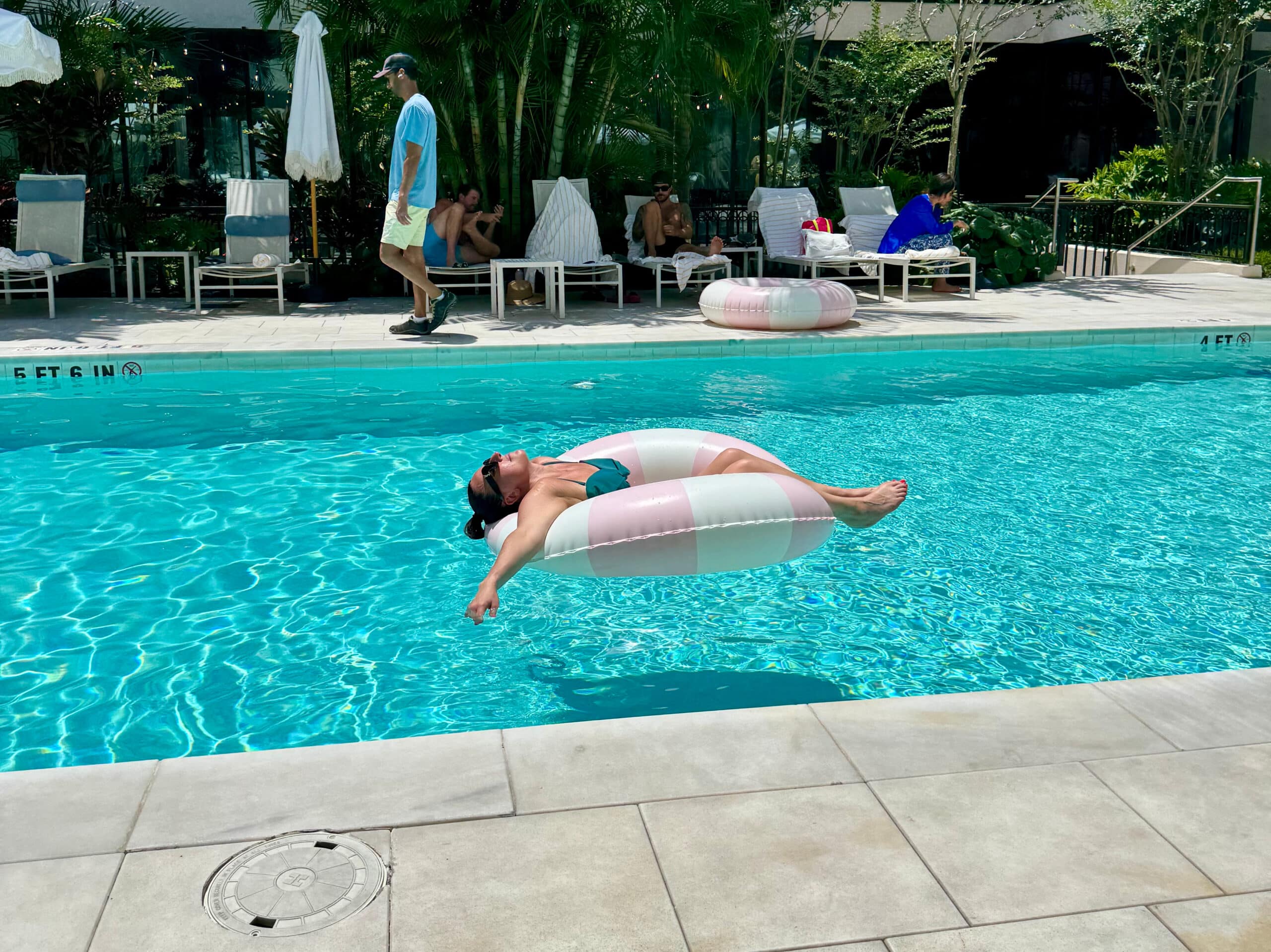 Liz laying on an inflatable tube in the pool at the hotel haya.