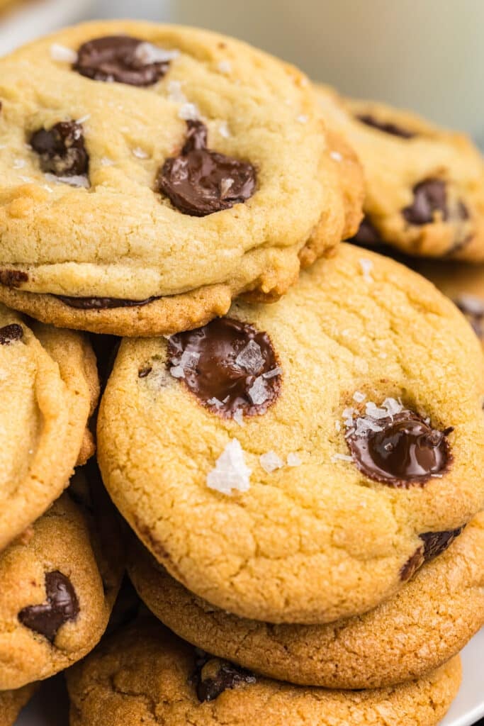 close up shot of chocolate chip cookies with melty chips, sprinkled with sea salt.