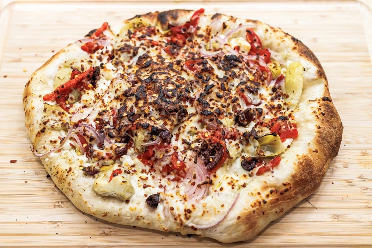 Cooked Mediterranean veggie pizza.