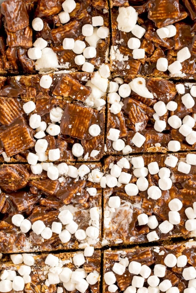 Top-down view of s’mores bars cut into squares and topped with mini marshmallows.