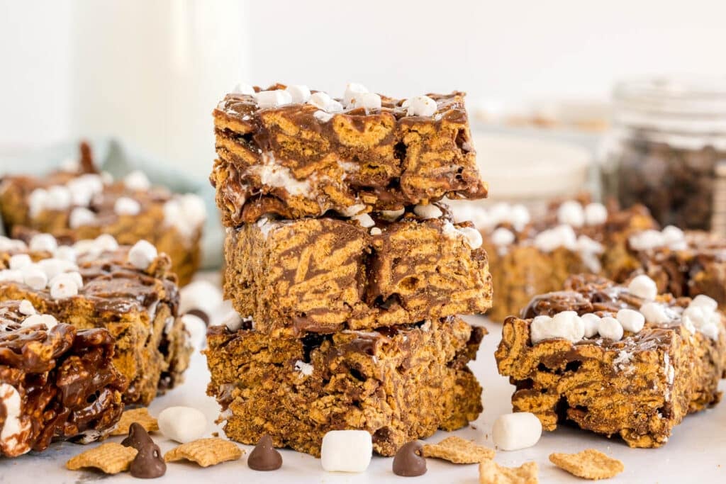 Three stacked s’mores bars with marshmallow and chocolate layers.