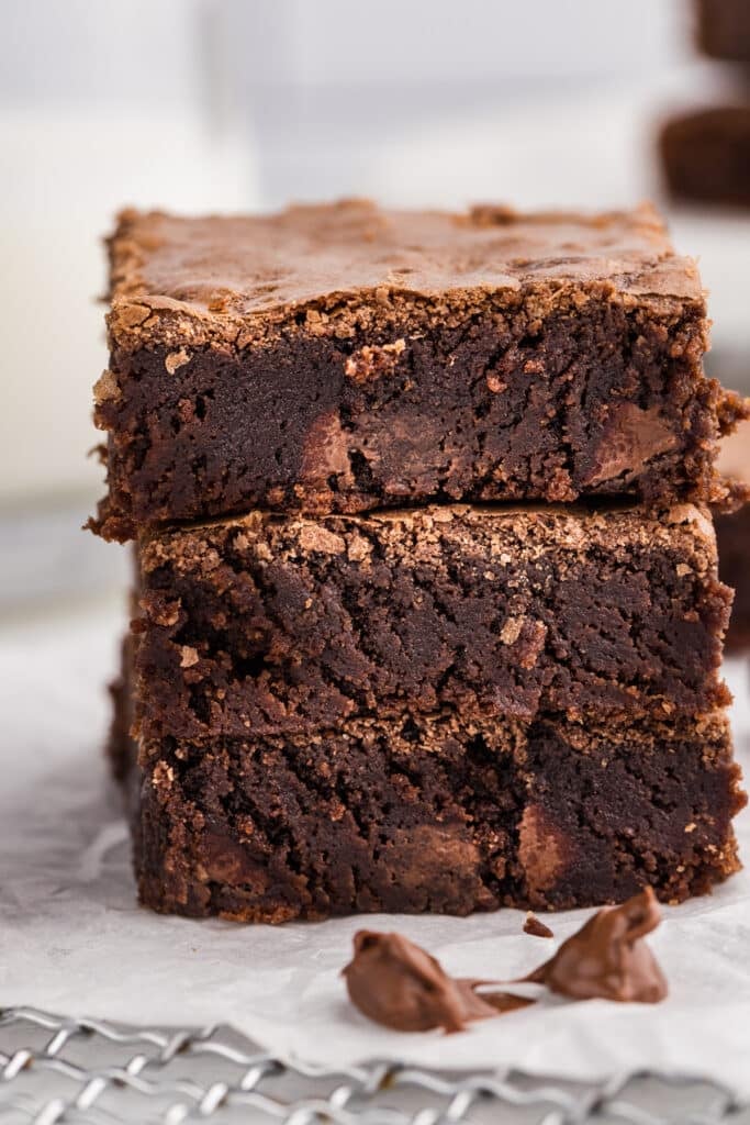 Three stacked brownies showing fudgy centers and crisp edges.