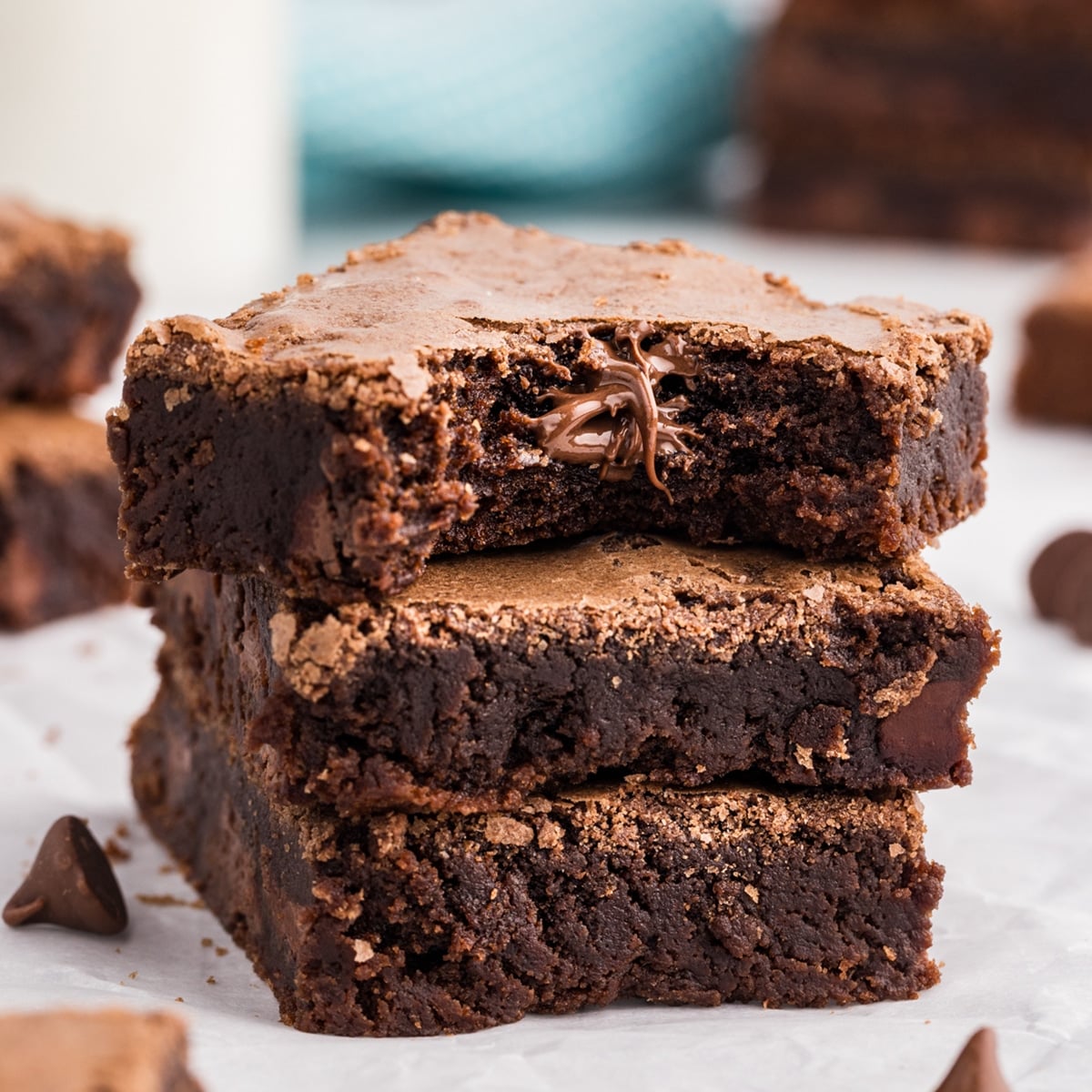 Stack of three brownies with melted chocolate center visible in top piece.