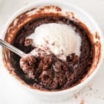 Warm single serve brownie topped with vanilla ice cream in a ramekin.