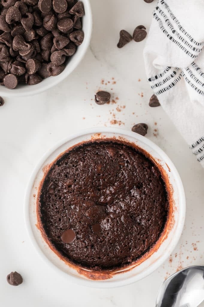 baked brownie in ramekin with chocolate chips.